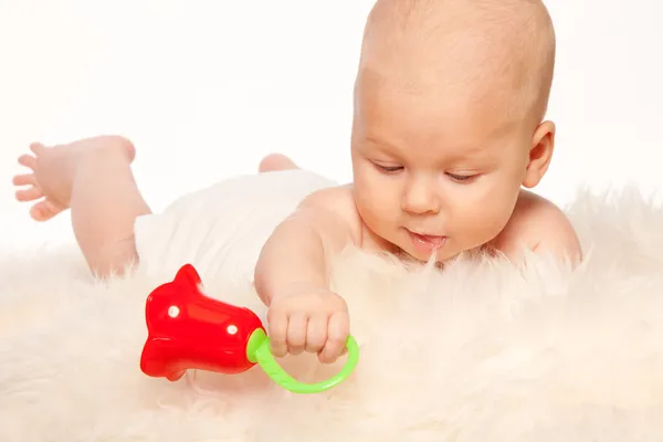 Младенец, играющий с грохотом — стоковое фото