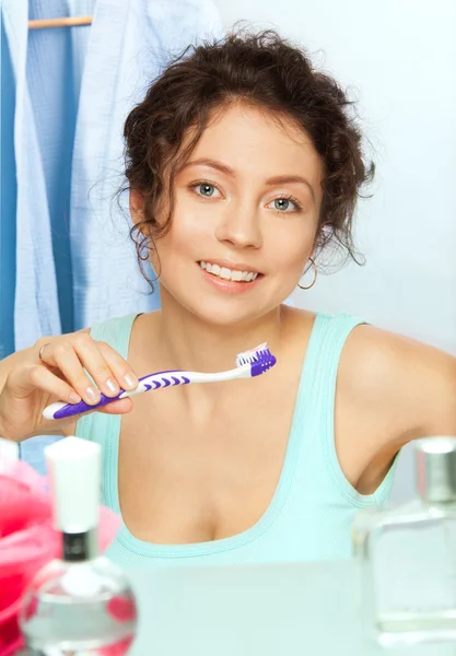 Toothbrush and smiling woman — Stock Photo, Image