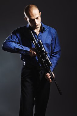 Handsome young man holding a gun clipart