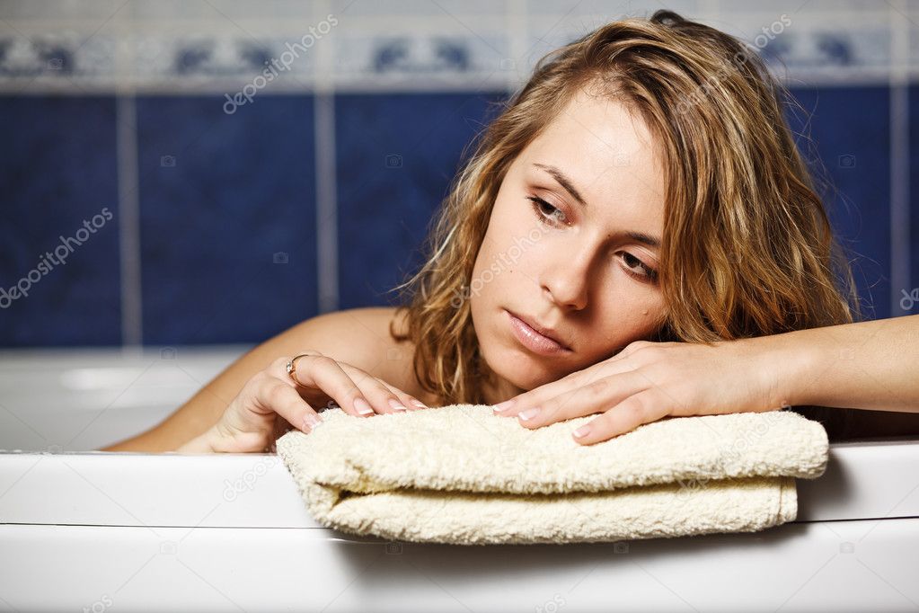 Woman in the bath laying on the towel