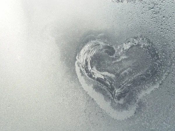 stock image Frozen heart in the frosty window
