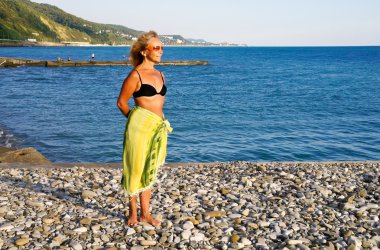 Woman stands on sea coast clipart