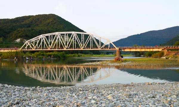 Bridge through mountain river — Stock Photo, Image