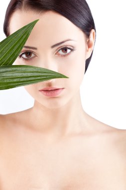 Beauty woman portrait with two green leaves clipart