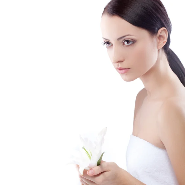 Serioulsy woman holding lily flower — Stock Photo, Image