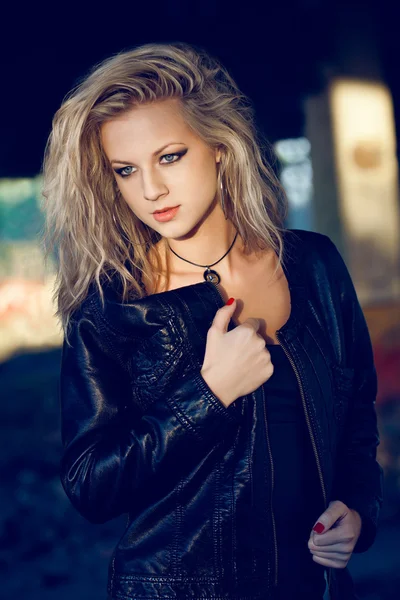 Woman looking down wearing leather jacket — Stock Photo, Image