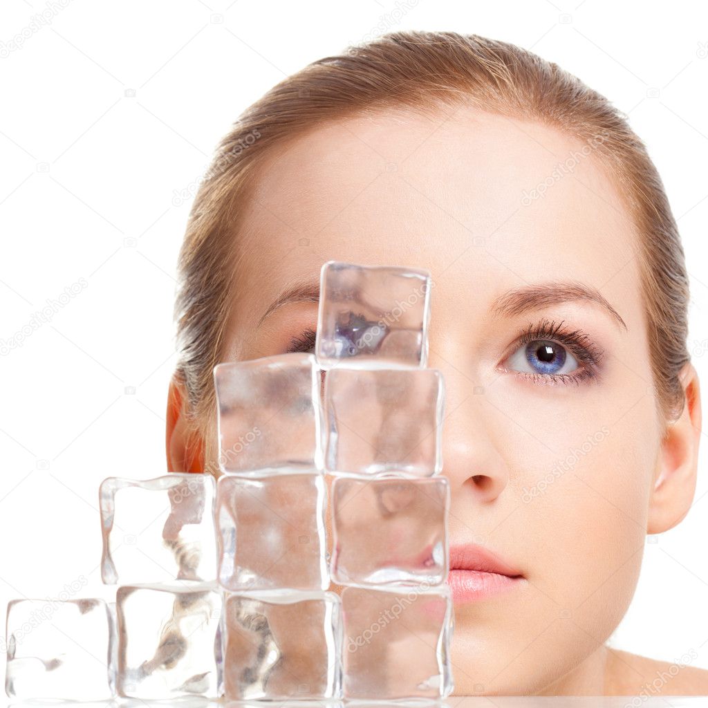 Beautiful woman face near ice cubes