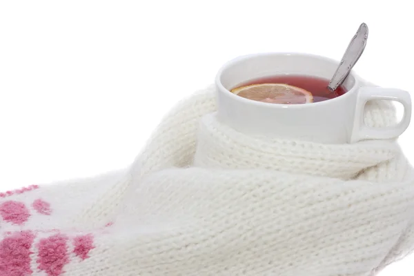 Hot fruit tea with lemon wrapped in a scarf — Stock Photo, Image