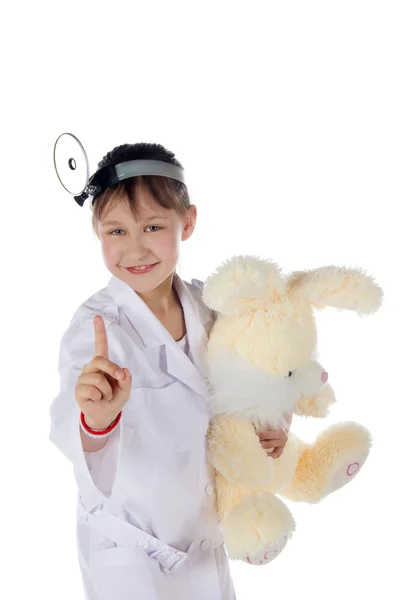 Menina, um médico, a criança, brinquedo de coelho — Fotografia de Stock