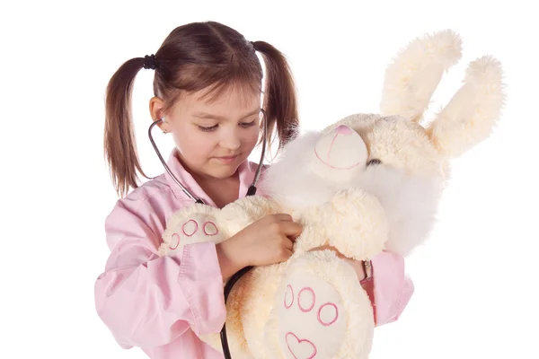 Chica, un médico, el niño, juguete de conejo — Foto de Stock