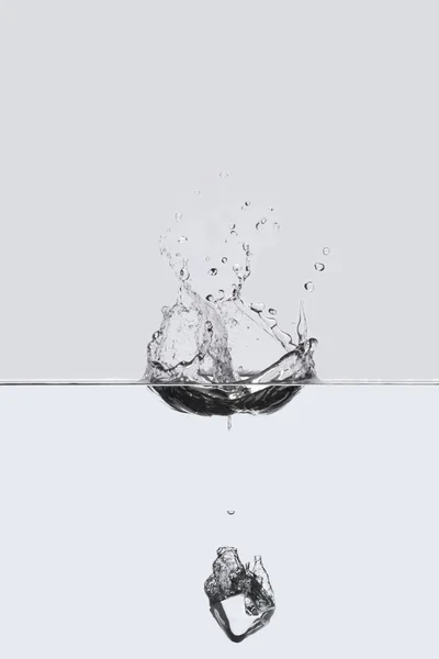 Gota de cubo gelado na água — Fotografia de Stock