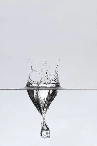 Gota de cubo gelado na água — Fotografia de Stock