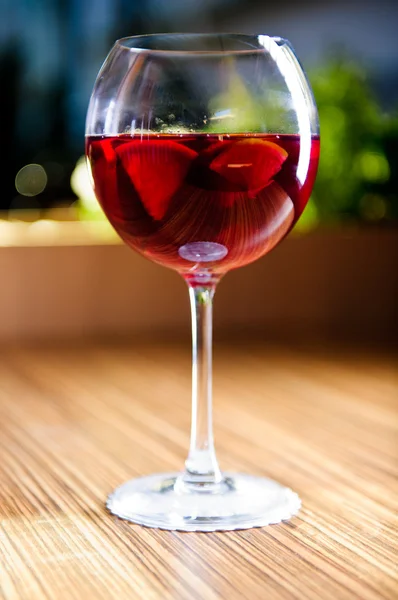 Glass of red wine with fruits — Stock Photo, Image