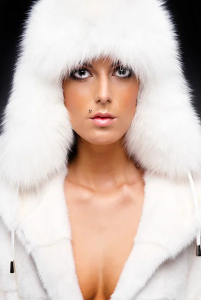 Beautiful woman in white fur coat and cap — Stock Photo, Image