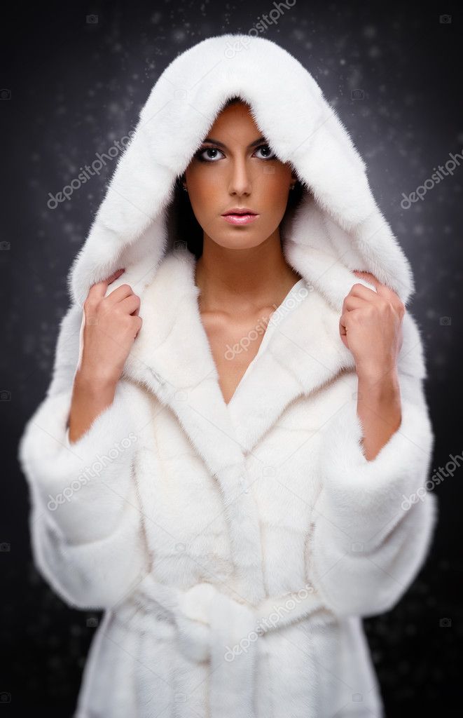 Beautiful woman in white fur coat