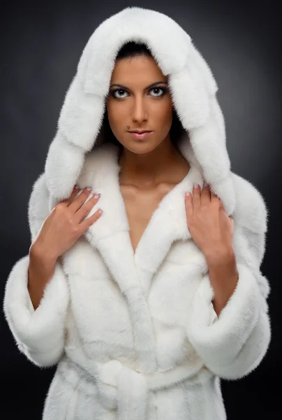 Beautiful woman in white fur coat — Stock Photo, Image