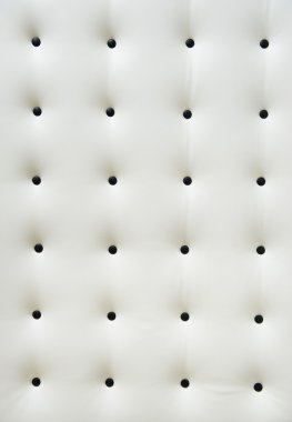 White leather upholstery with black buttons clipart