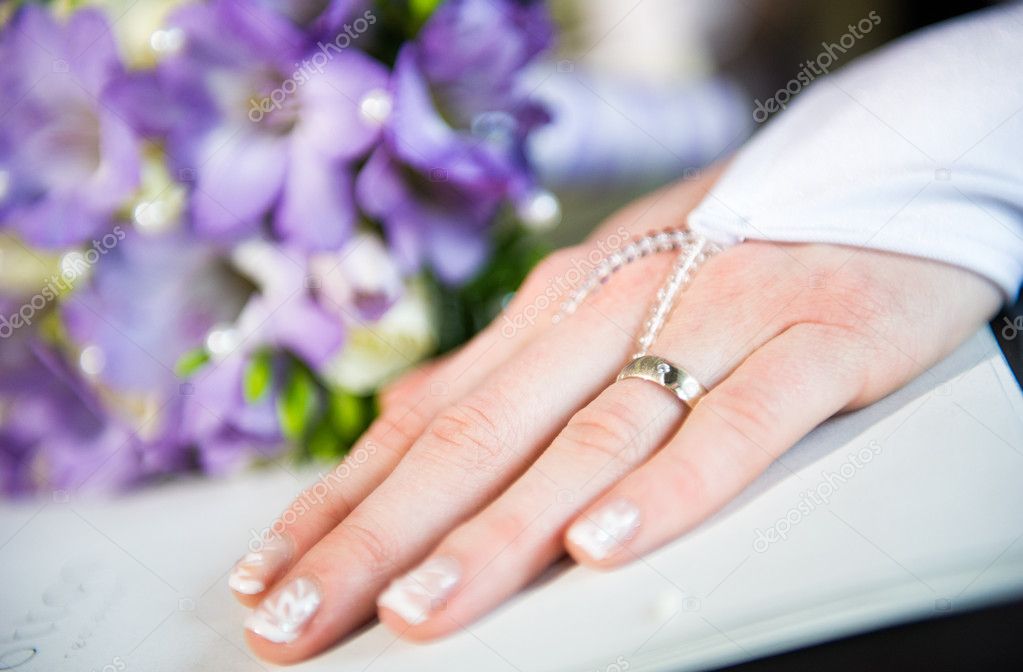 Beautiful bride's hand with manicure in white glove