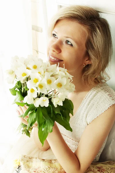 Woman with a bunch hellebore — Stock Photo, Image