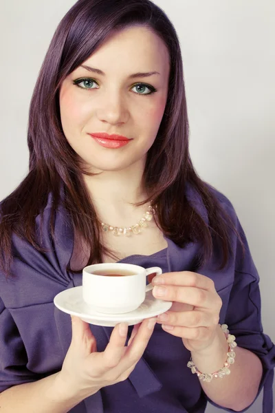 Beauty woman holds cup — Stock Photo, Image