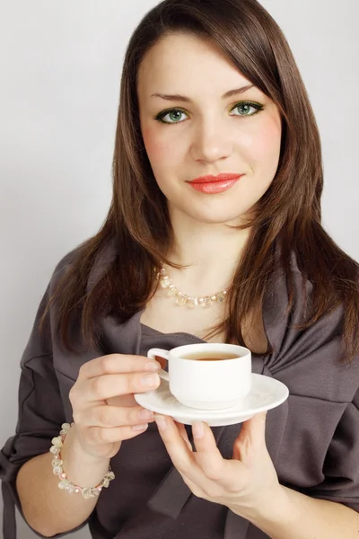 Young woman holds cup — Stock Photo, Image
