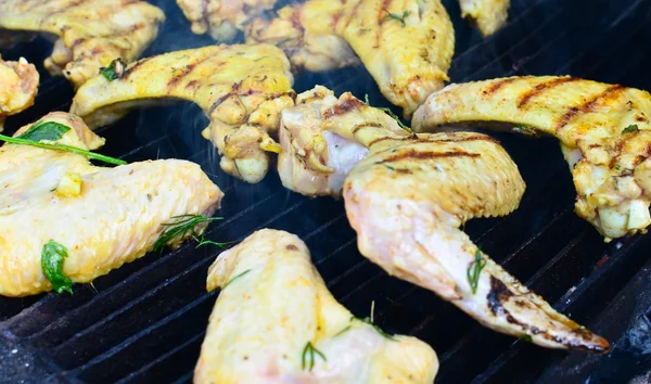 stock image Chicken wings on smoking grill closeup