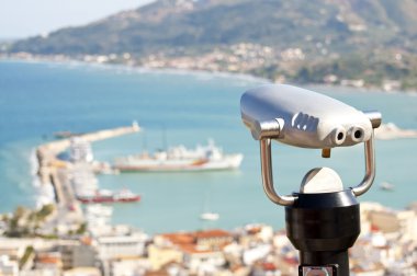 Binocular viewer looking out over small town clipart