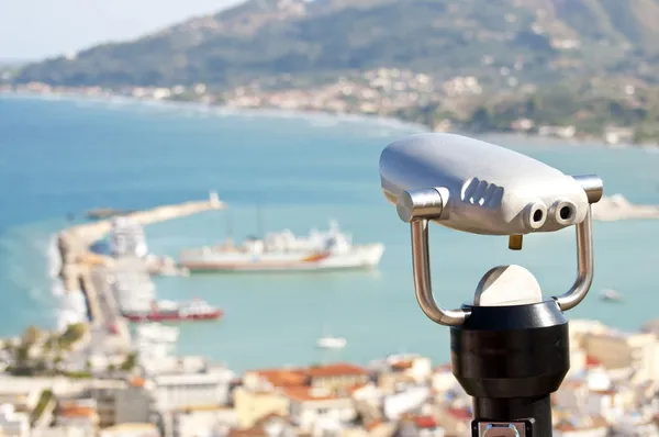 Binocular viewer looking out over small town — Stok Foto