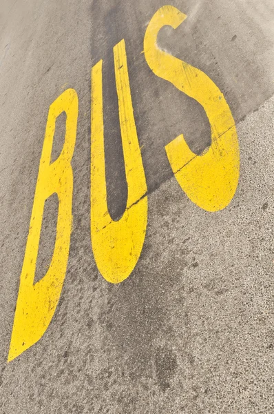 Gul buss tecken målade på asfalt — Stockfoto