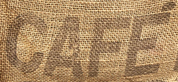 单词"咖啡馆"或者"咖啡"在旧麻袋上写 — 图库照片