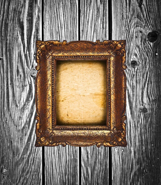 Vintage golden frame on wooden wall — Stock Photo, Image
