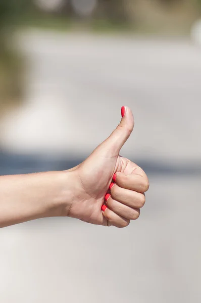 Woman hand hitchhiking — Stock Photo, Image