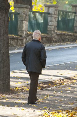 Old man walking in park clipart