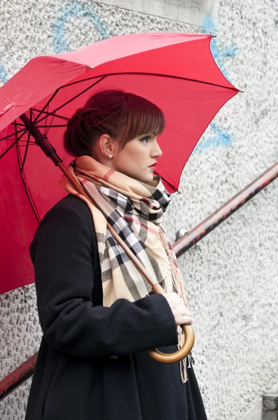 stock image Woman with red umbrella posing