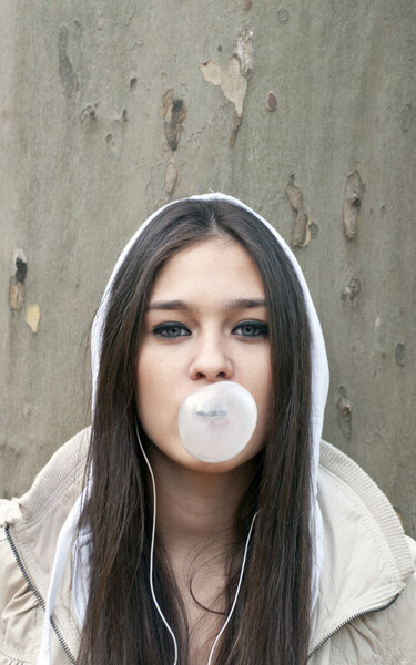 Portrait of young girl blowing bubble gum