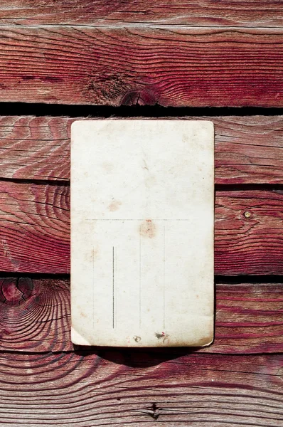 Пустая винтажная открытка на деревянной стене — стоковое фото
