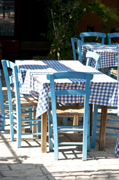 Greek restaurant with traditional blue table and chairs — Stock Photo, Image