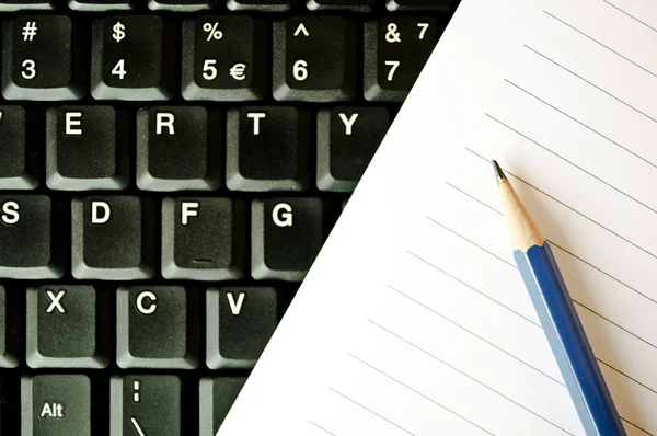 Pencil and notebook on keyboard — Stock Photo, Image