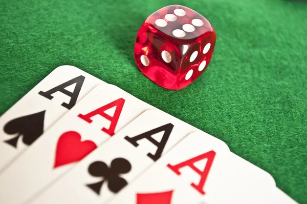 Four aces and red dice on green background — Stock Photo, Image