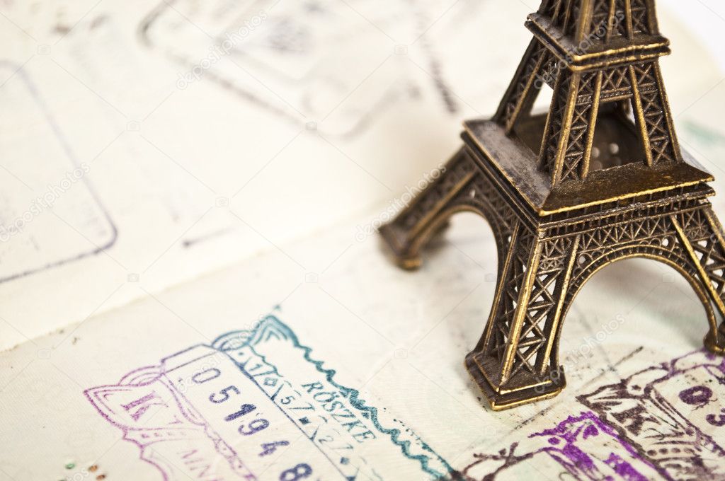 Stamped passport with Eiffel passport - travel to Paris concept