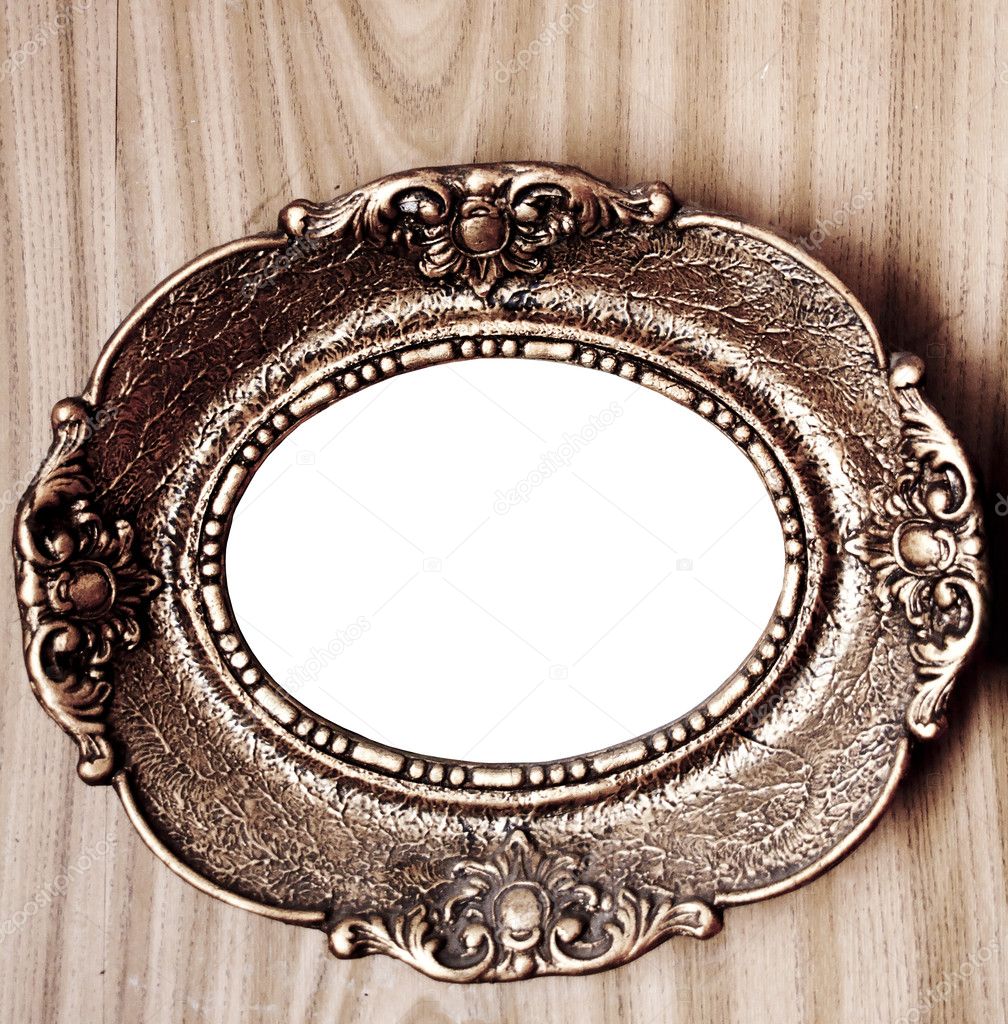 Empty golden vintage frame on wooden wall