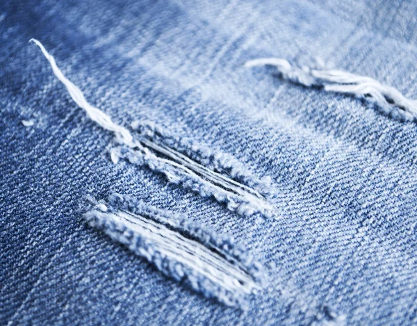 stock image Closeup of tear in old jeans