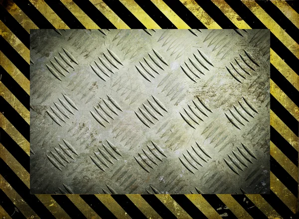 Diamond metal template with yellow warning stripes background — Stock Photo, Image