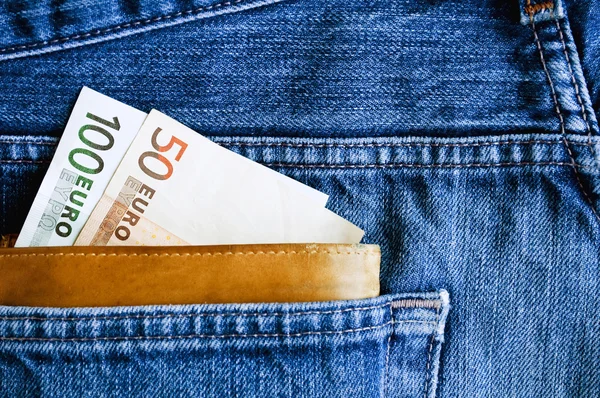 Portefeuille met euro's in jeans zak — Stockfoto
