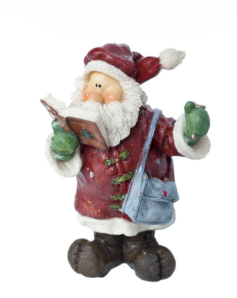 Papai Noel figurine leitura livro isolado no fundo branco — Fotografia de Stock