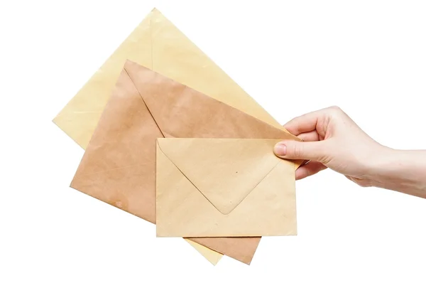 Envelopes amarelos na mão isolados sobre fundo branco — Fotografia de Stock