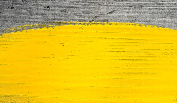 Yellow paint on old wooden background — Stock Photo, Image