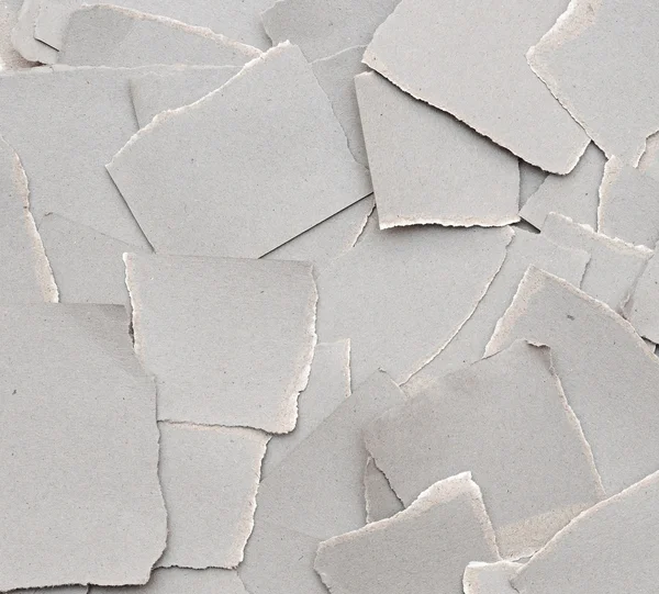 Sammlung zerrissene graue Kartonstücke auf weißem Hintergrund — Stockfoto