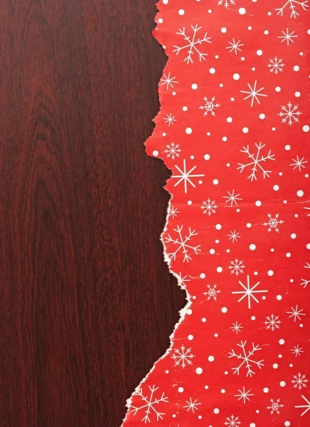 Torn Christmas decorative paper over wood background — Stock Photo, Image