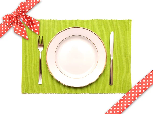 Knife, fork and white plate on a green napkin — Stock Photo, Image